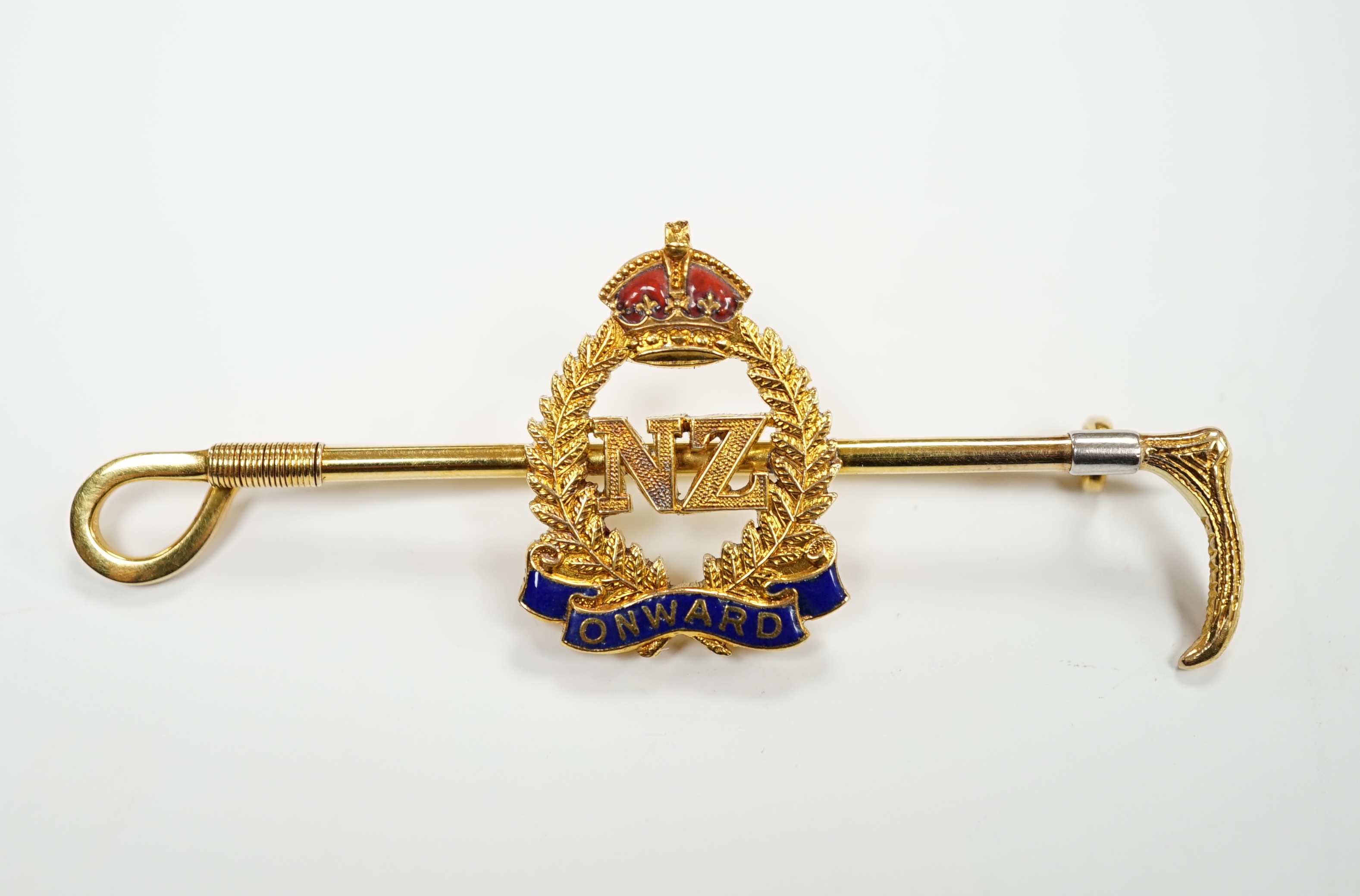 A 1940's 9ct, plat. and two colour enamel set New Zealand Infantry and riding crop sweethearts bar brooch, with engraved inscription, 65mm